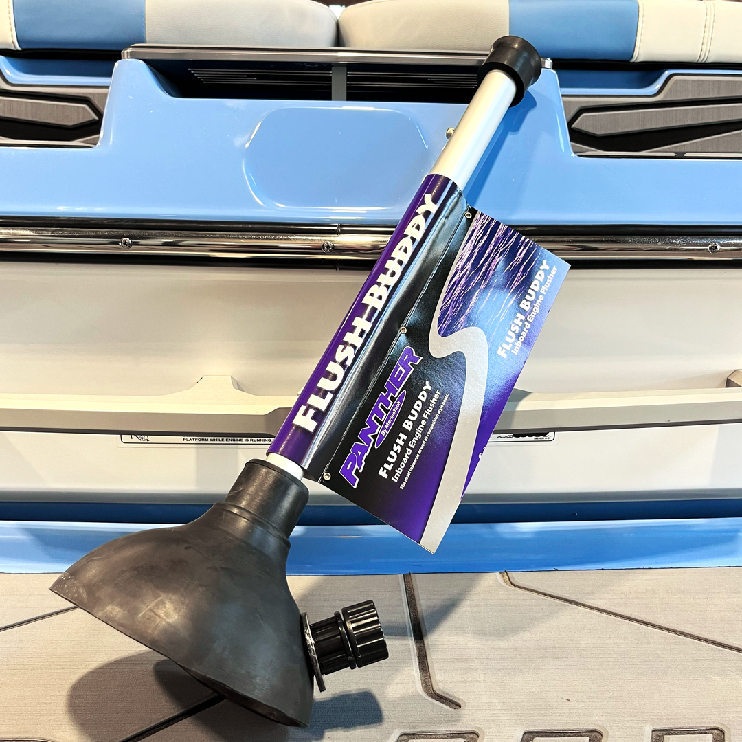 Inboard winterizing kit with a push-button engine flush nozzle, black rubber base, and purple and white packaging.