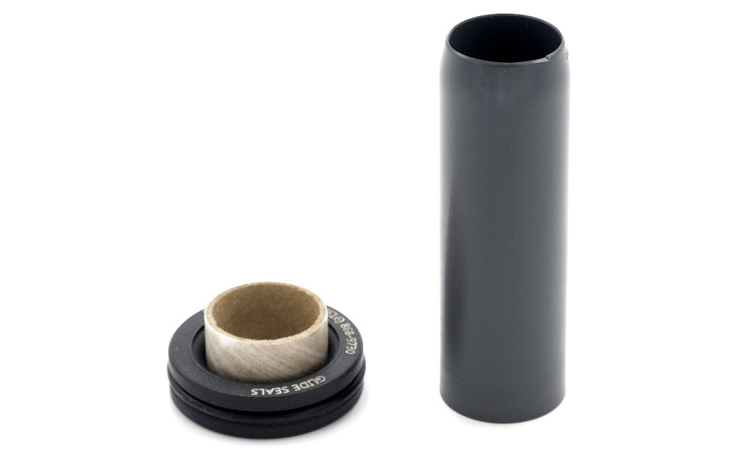 Black shaft seal with 1-1/4-inch diameter, shown alongside a cylindrical pipe for sealing and protection.