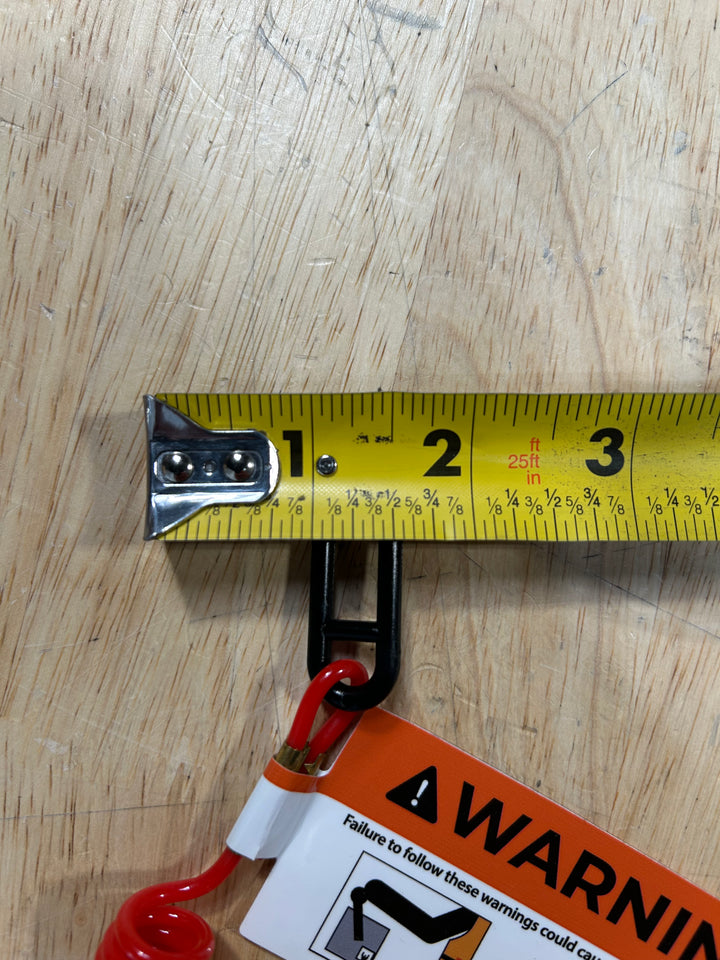 Kill switch lanyard displayed next to a measuring tape, highlighting its length and safety warning label.