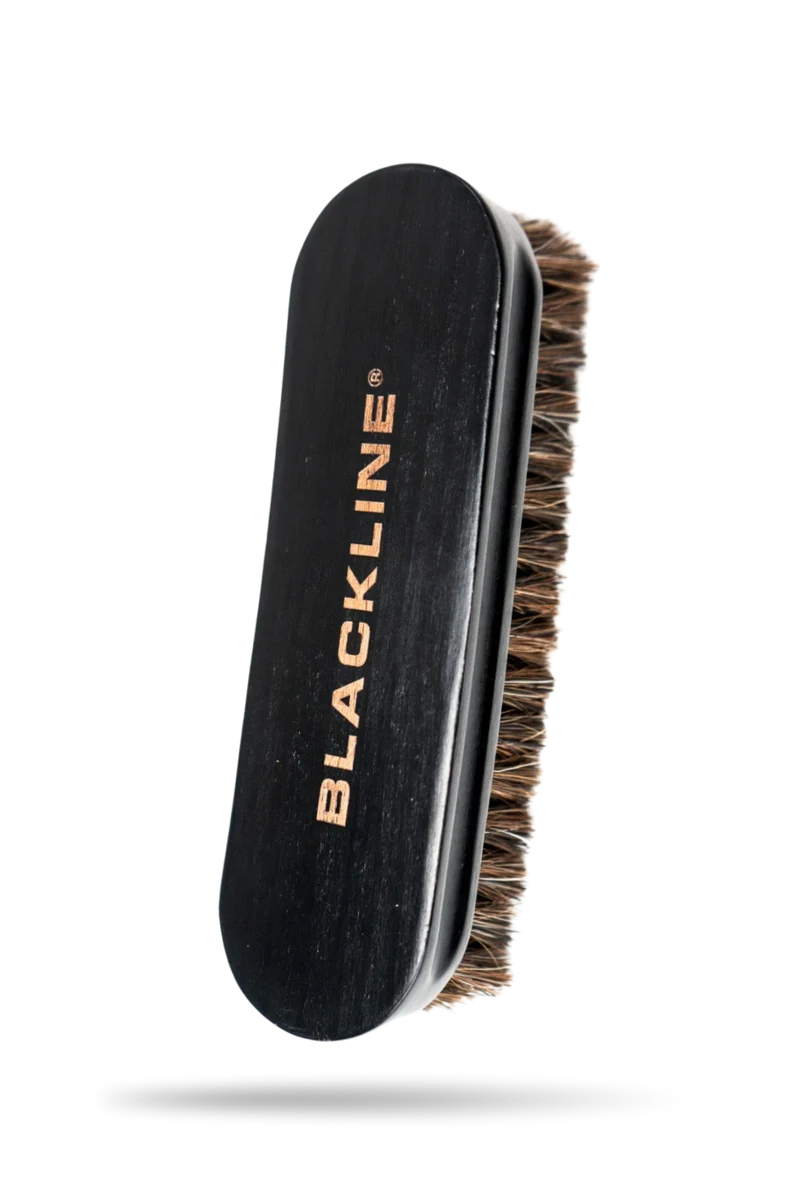 Leather brush with a wooden handle and soft bristles, designed for cleaning and maintaining leather goods.