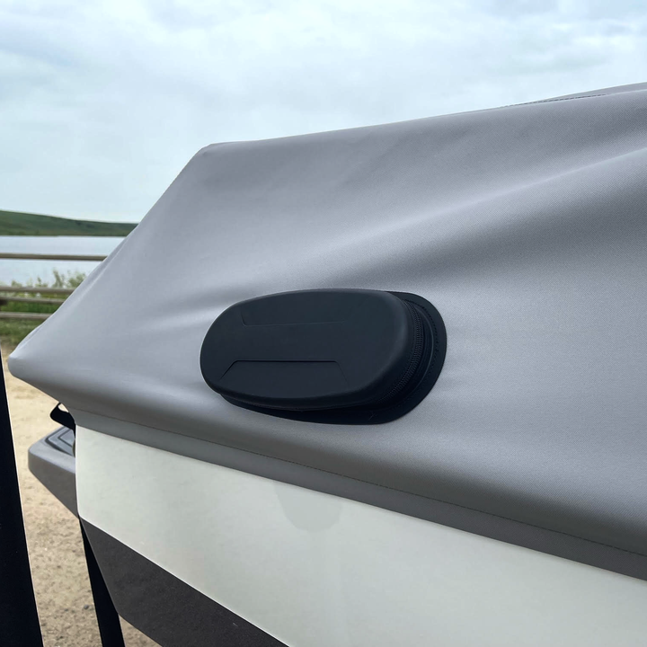 Close-up of a T22 Cover on the FatAX Tower, featuring a black, oval-shaped protective case mounted on a silver surface outdoors.
