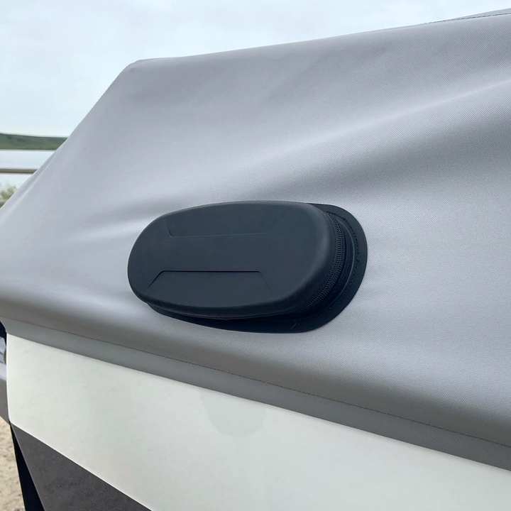 Close-up of the Axis A20 FatAX Tower antenna mounted on a white surface, with a black protective cover and textured fabric background.