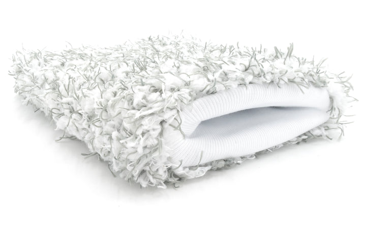 White microfiber wash mitt with soft, textured surface and plush, shaggy exterior for gentle car cleaning.