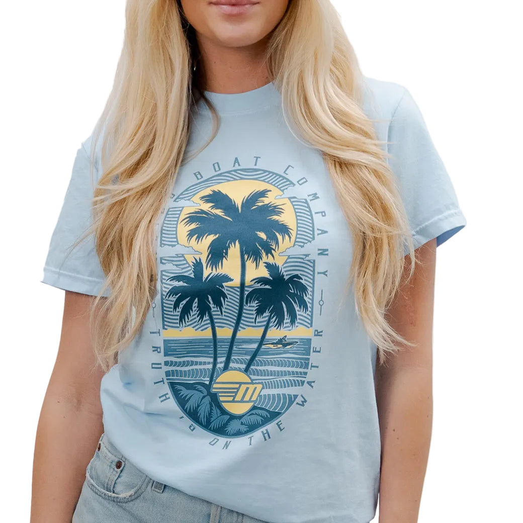 Light blue T-shirt featuring a graphic of palm trees, a sunset, and the text "Boat Company" and "On the Water.