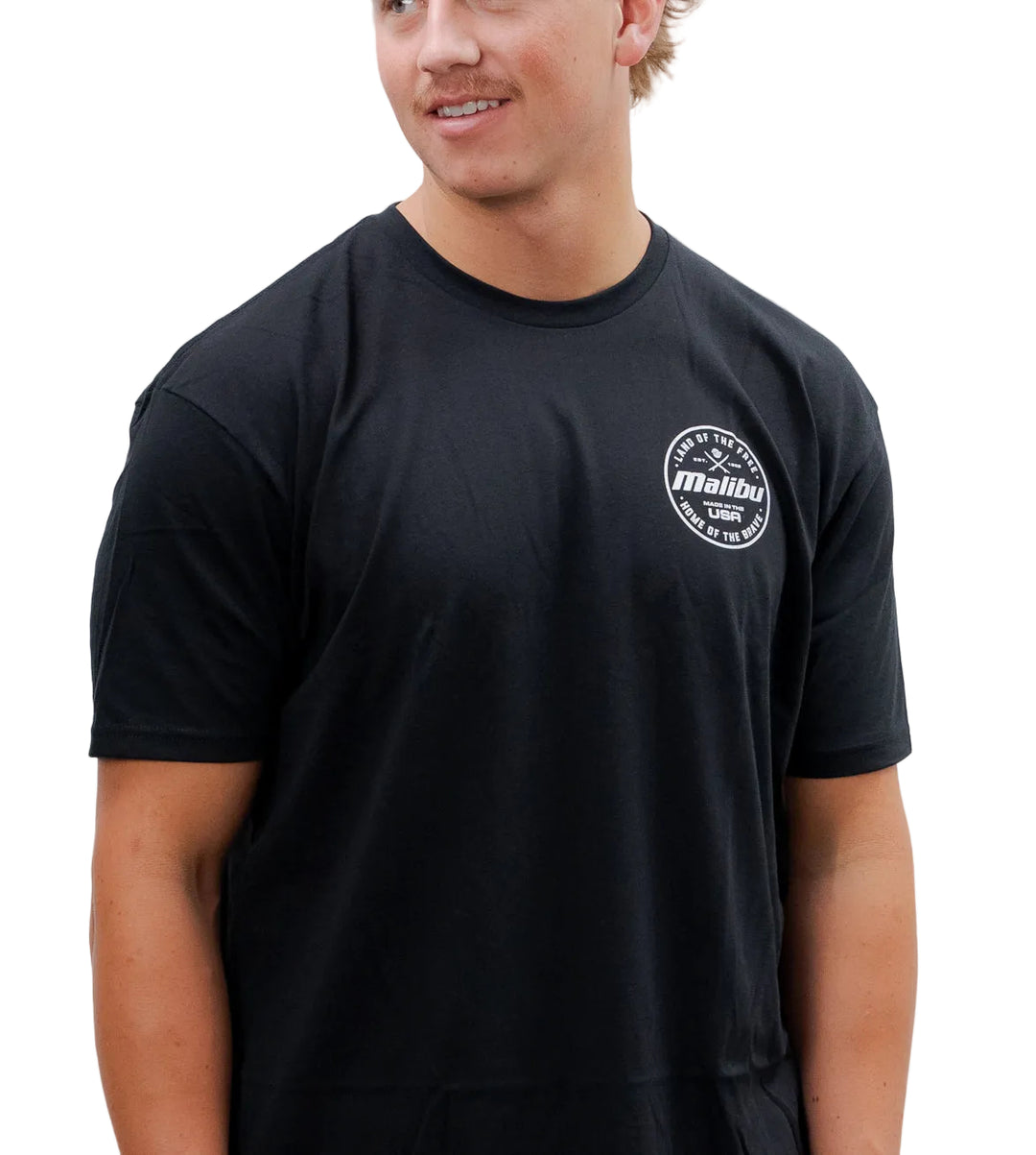Black Malibu Brave T-shirt with a small white circular logo on the chest reading "Land of the Free, Made in the USA, Home of the Brave.