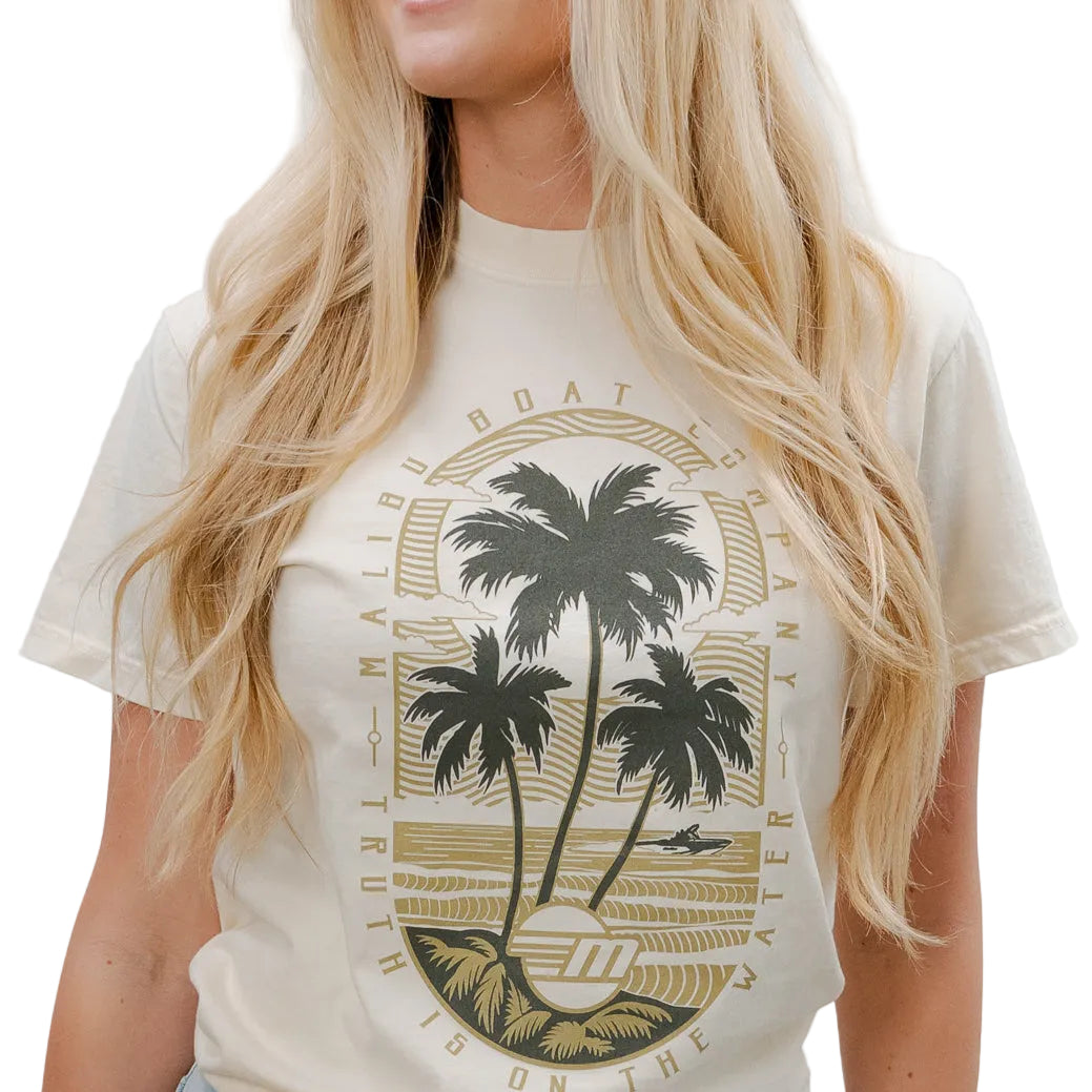 Cream-colored Malibu Beach Tee featuring a graphic of palm trees, ocean, and surf, perfect for casual beachwear.