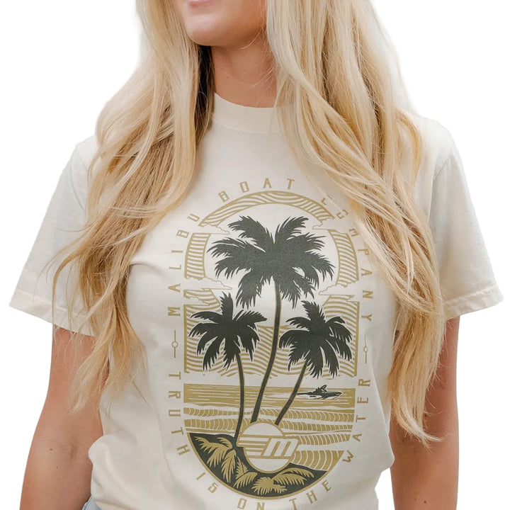 Cream-colored Malibu Beach Tee featuring a graphic of palm trees, ocean, and surf, perfect for casual beachwear.