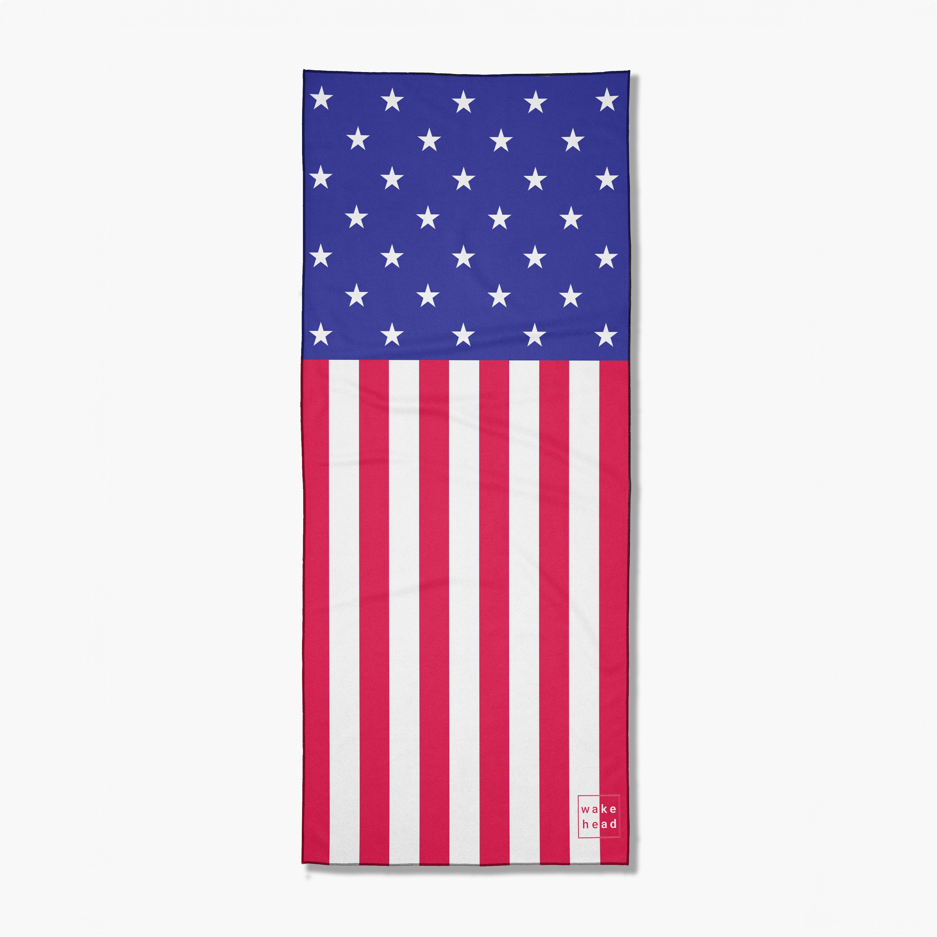 Patriot's Lake towel featuring an American flag design with stars on a blue field and red and white stripes, branded with Wake Head.