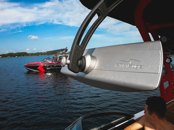 G3 arm replacement knob attached to a boat, with a speedboat on the water in the background under a blue sky.