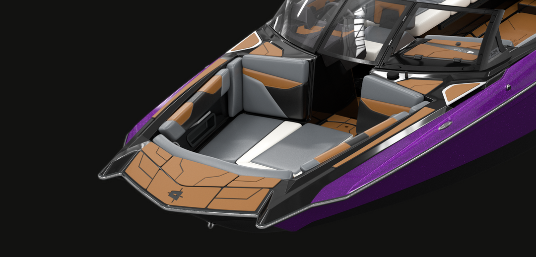 Close-up of a brushed stainless steel formed bow rub rail on a purple and black boat with tan and gray interior accents.
