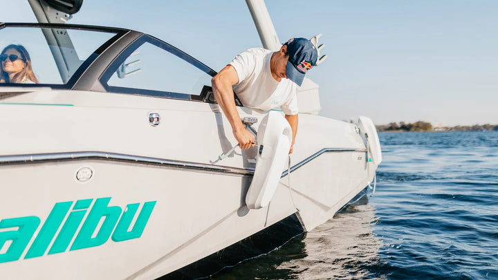 Man attaching Mission Boat SENTRY 2.0 boat fenders to a boat&