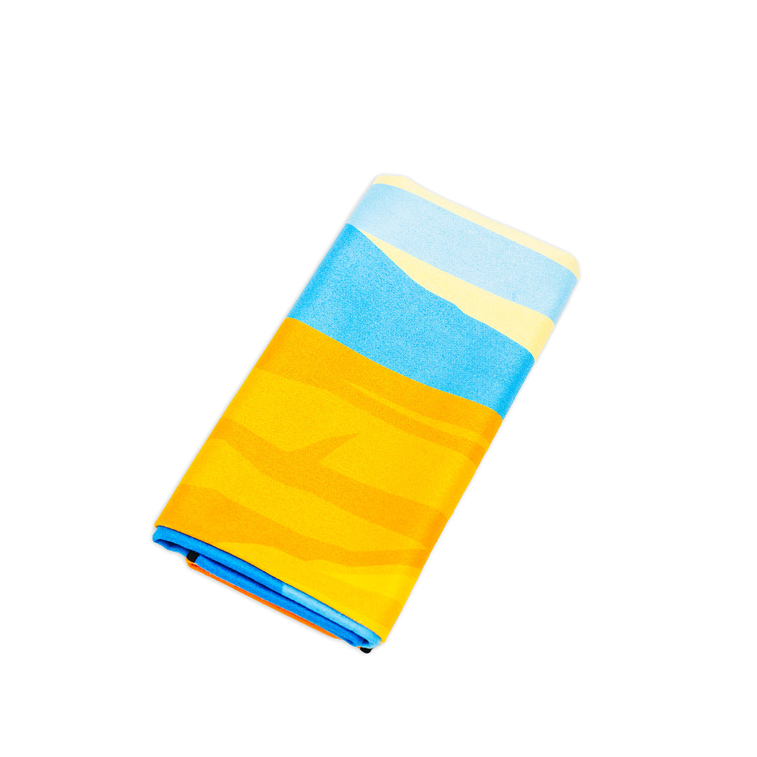 Colorful Powell Towel with blue, yellow, and cream stripes, neatly folded on a white background.