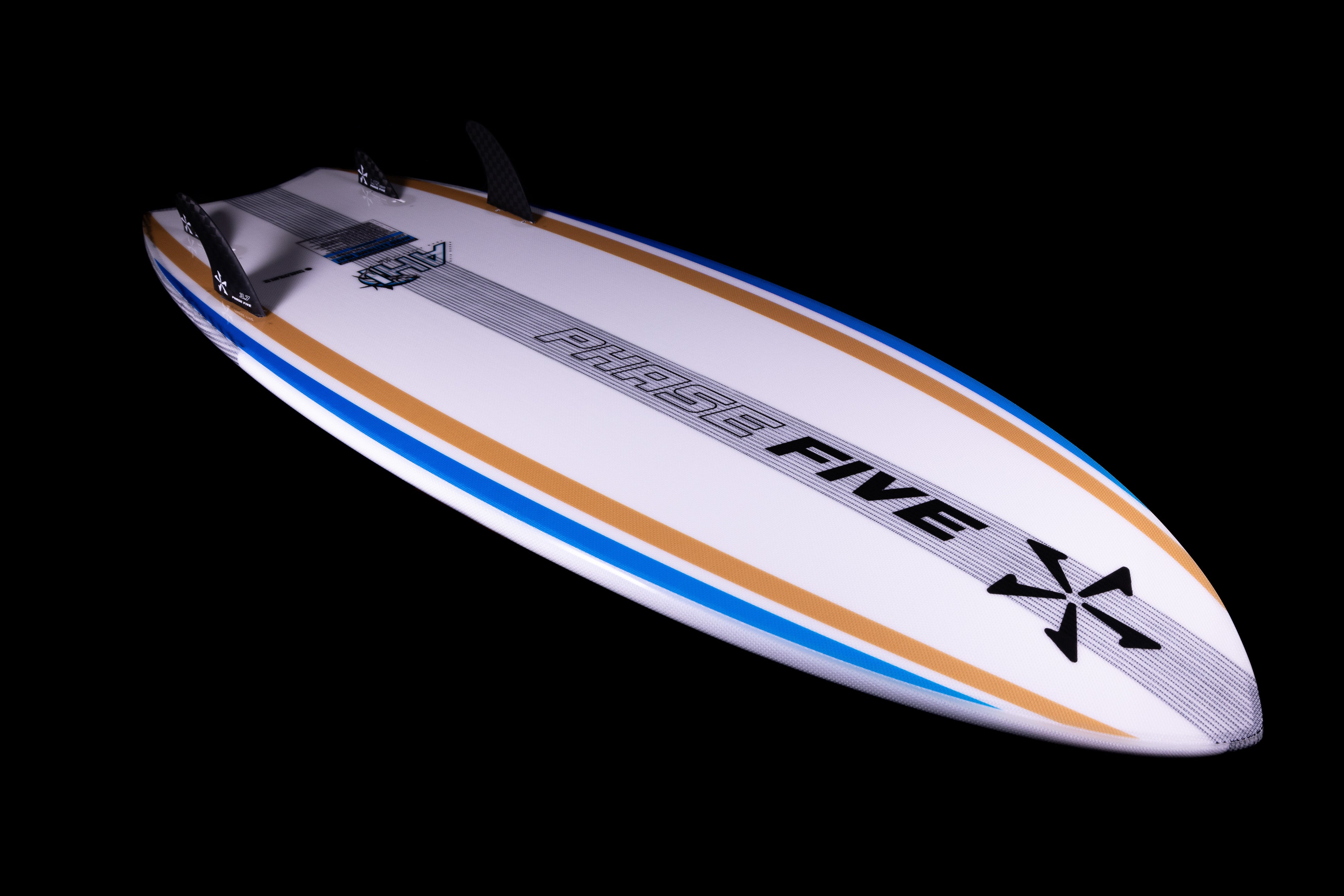2025 Phase 5 Ahi surfboard with a white deck, black fins, and colorful blue and tan accents, shown against a black background.