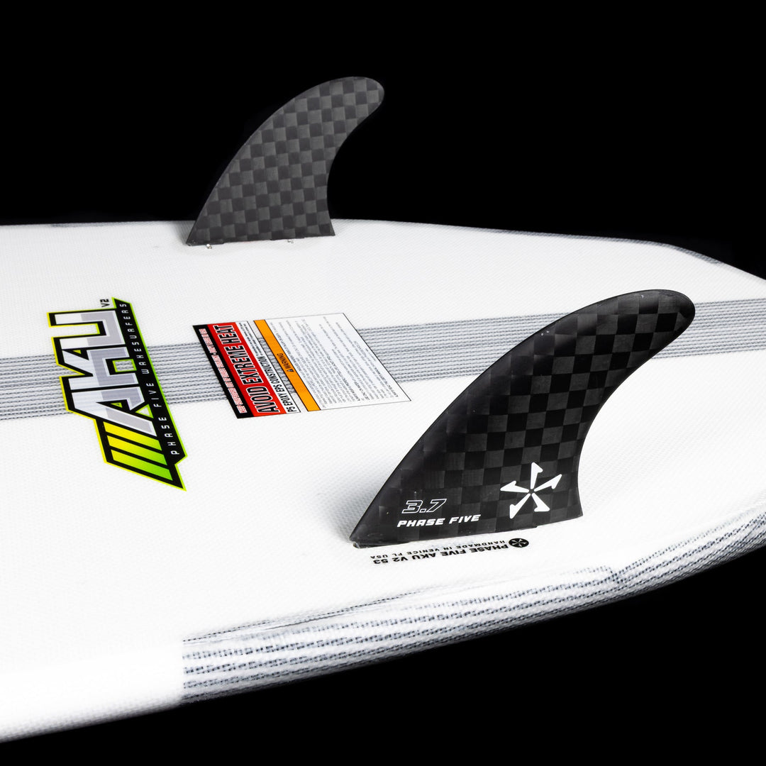 Close-up of the 2026 Phase Five Aku V2 surfboard featuring carbon fins and a sleek design for optimal performance.