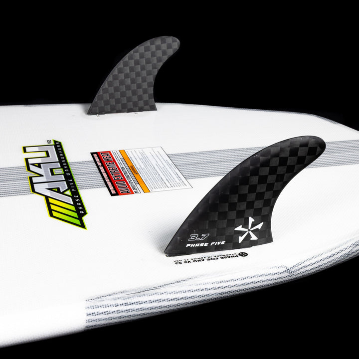 Close-up of the 2026 Phase Five Aku V2 surfboard featuring carbon fins and a sleek design for optimal performance.