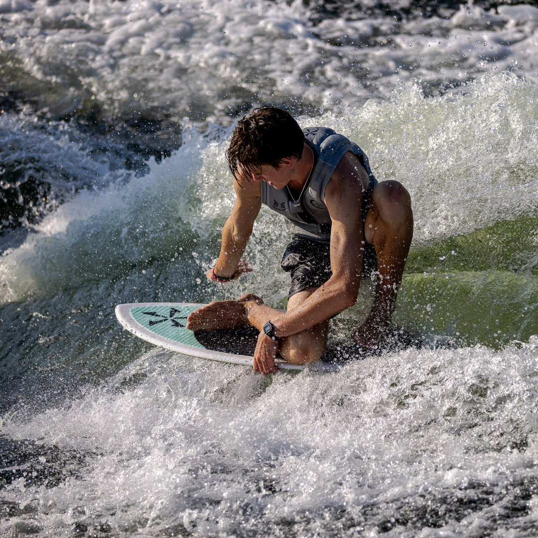 A rider performs a maneuver on the 2026 Phase Five Avenger surfboard, showcasing agility on a wave.