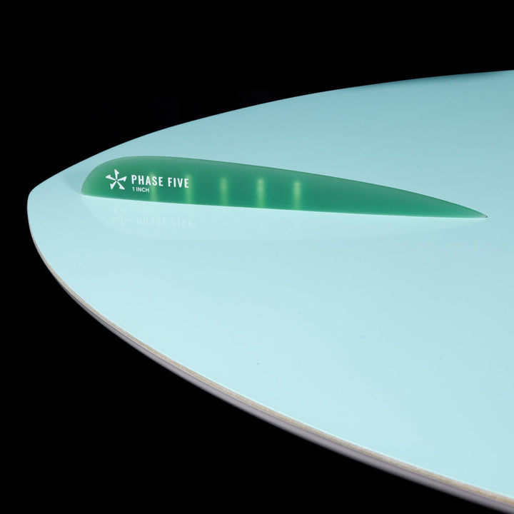 2026 Phase Five Avenger surfboard with a sleek design and vibrant green fin, ideal for high-performance water sports.
