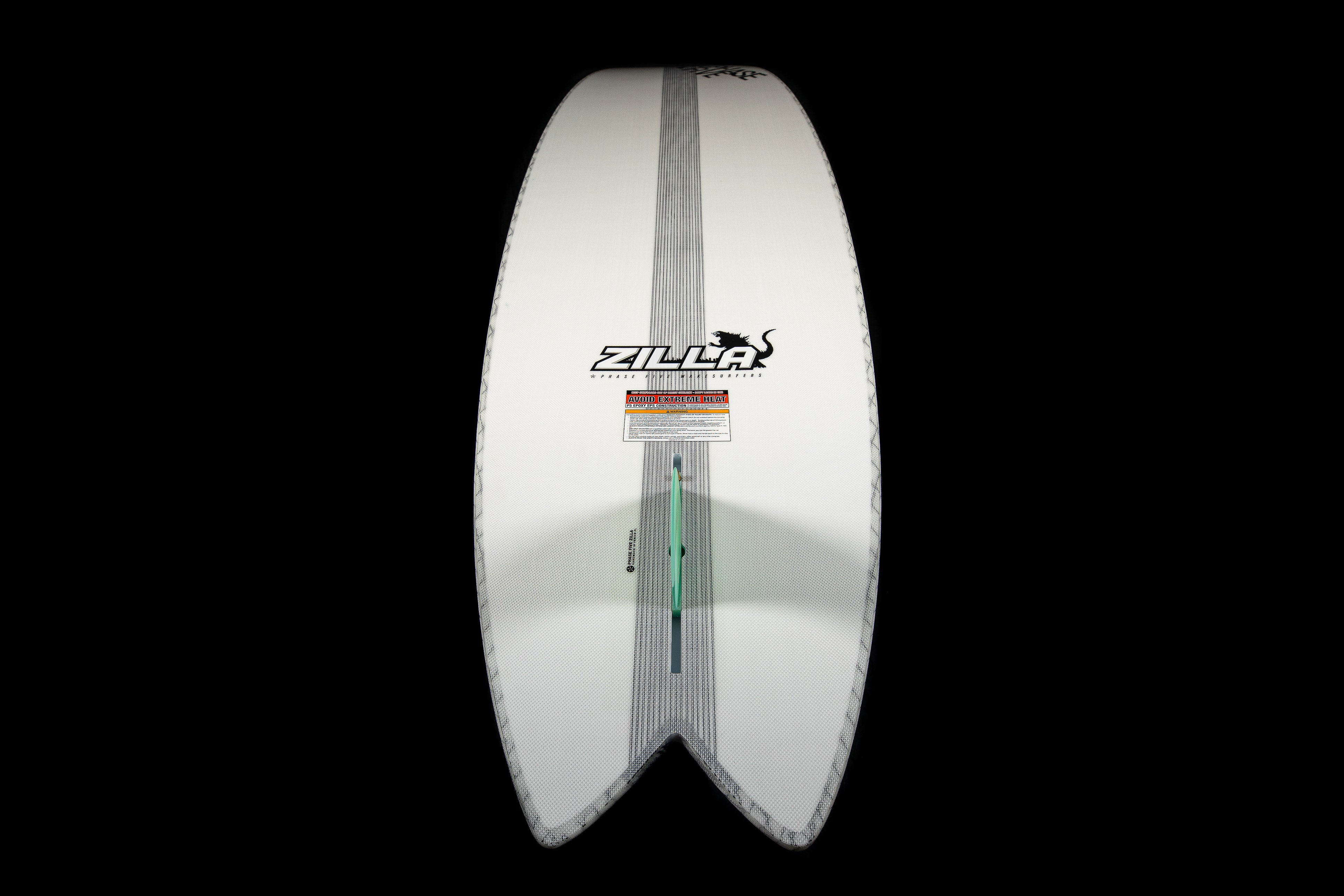 White 2025 Phase 5 Zilla surfboard with black logo, gray stripe, and a green fin, displayed against a black background.