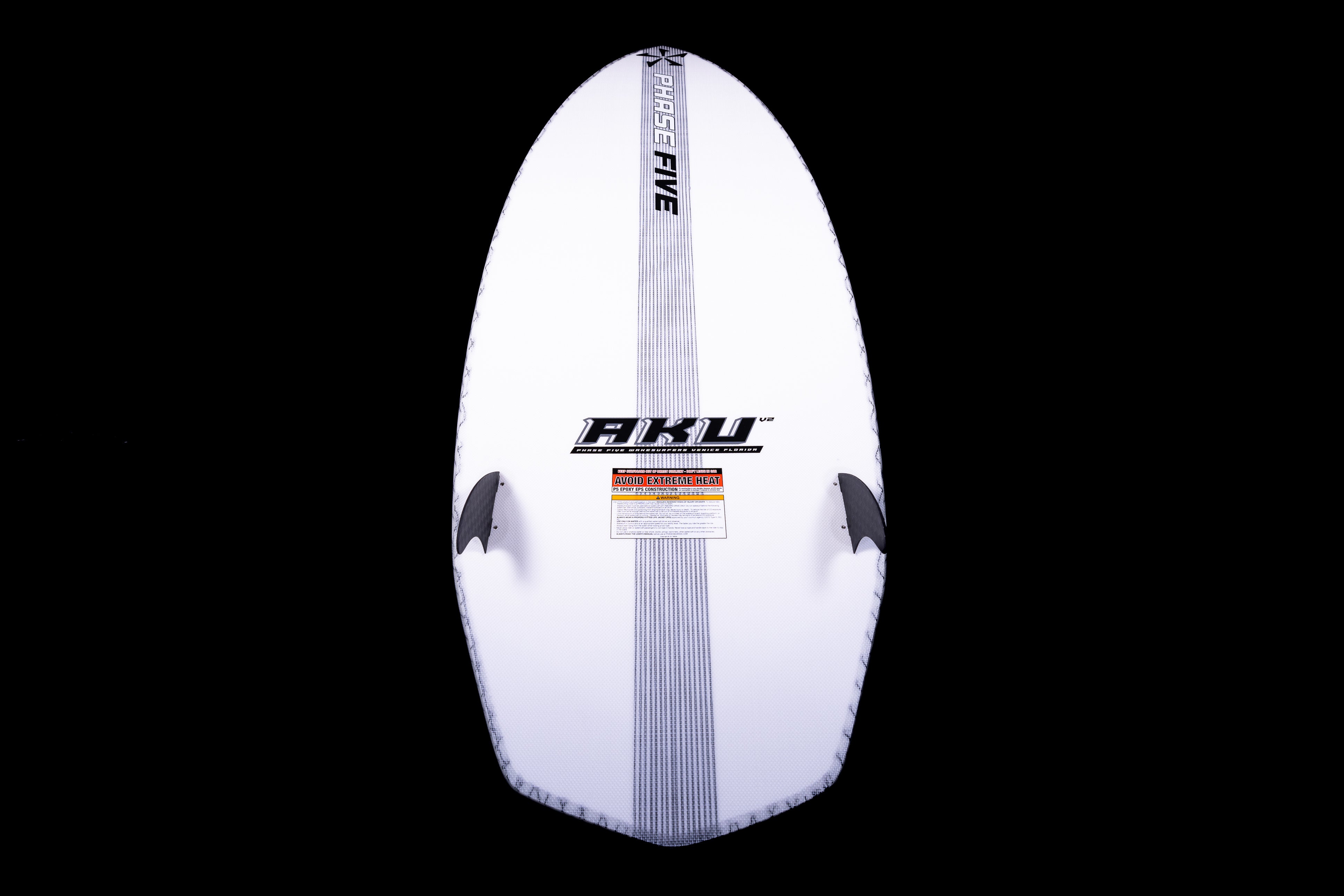 White 2025 Phase 5 Aku surfboard with black fins and branding, shown against a black background.