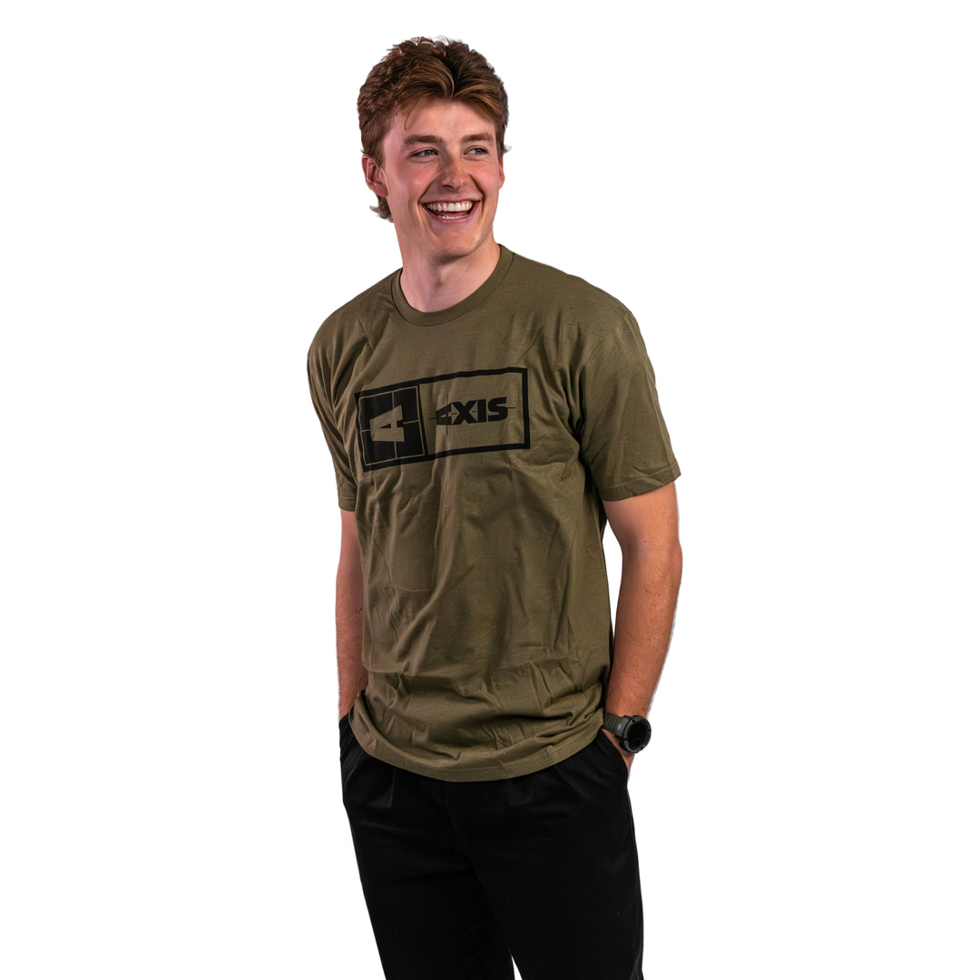 Man wearing an olive green Axis Statement Tee with a black logo, smiling against a light background.