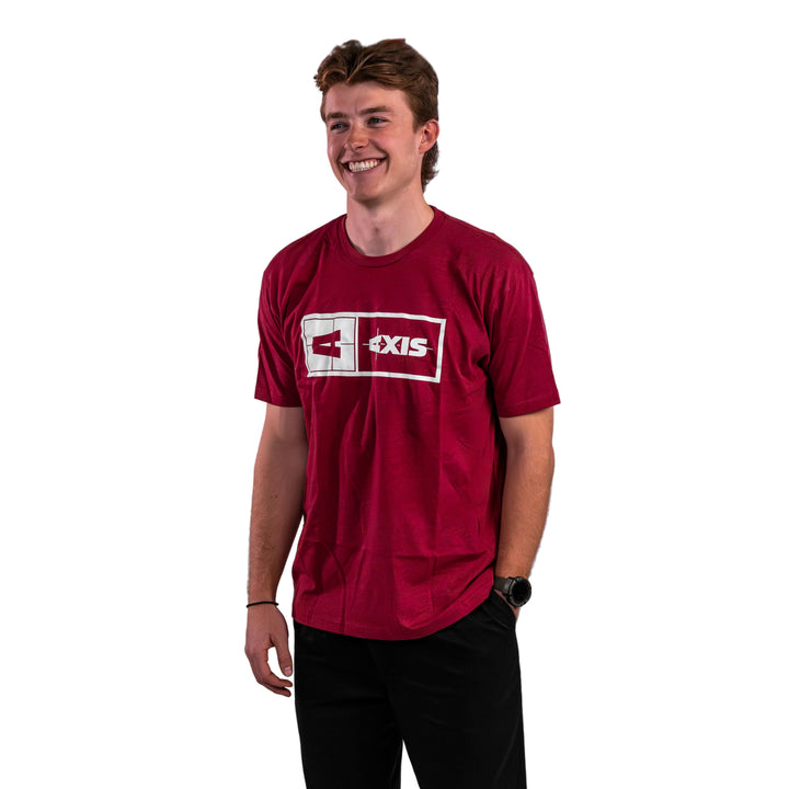 A young man wearing a maroon Axis Statement Tee, smiling against a neutral background.