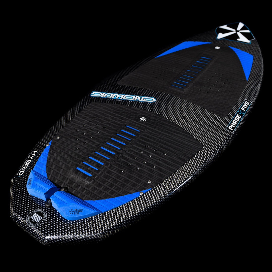 2026 Phase Five Diamond Turbo surfboard featuring a sleek carbon fiber design with blue accents and a hybrid shape.