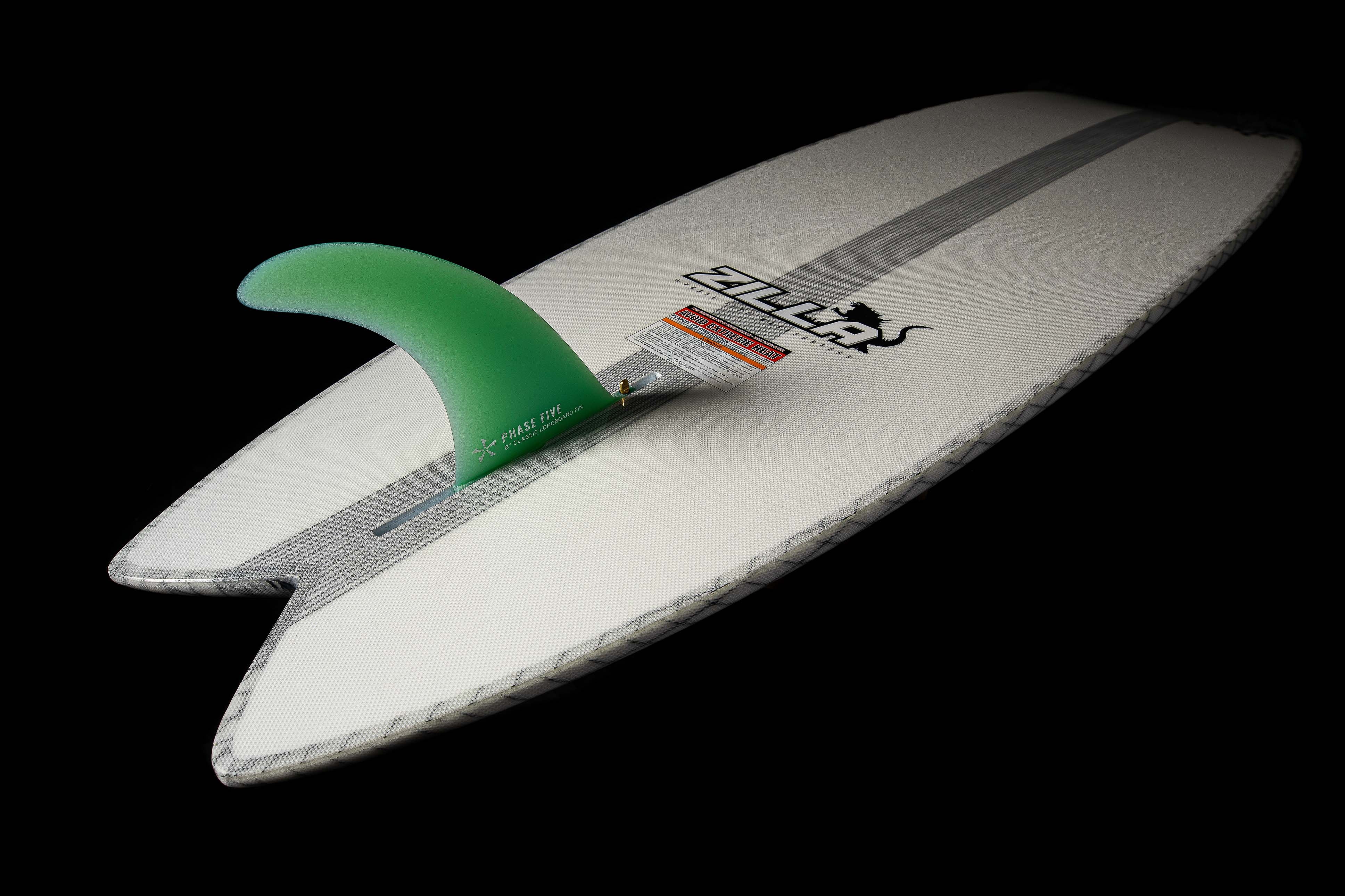 2025 Phase 5 Zilla surfboard with a white deck, black logo, and a green fin, designed for high-performance surfing.