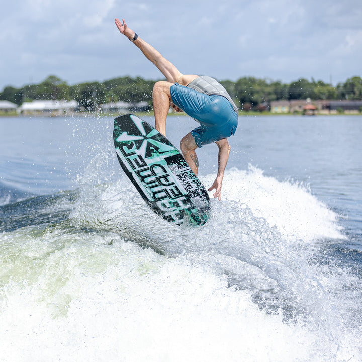 Rider performing a trick on the 2026 Phase Five Hammerhead V3 wake surfboard, creating a spray of water behind.