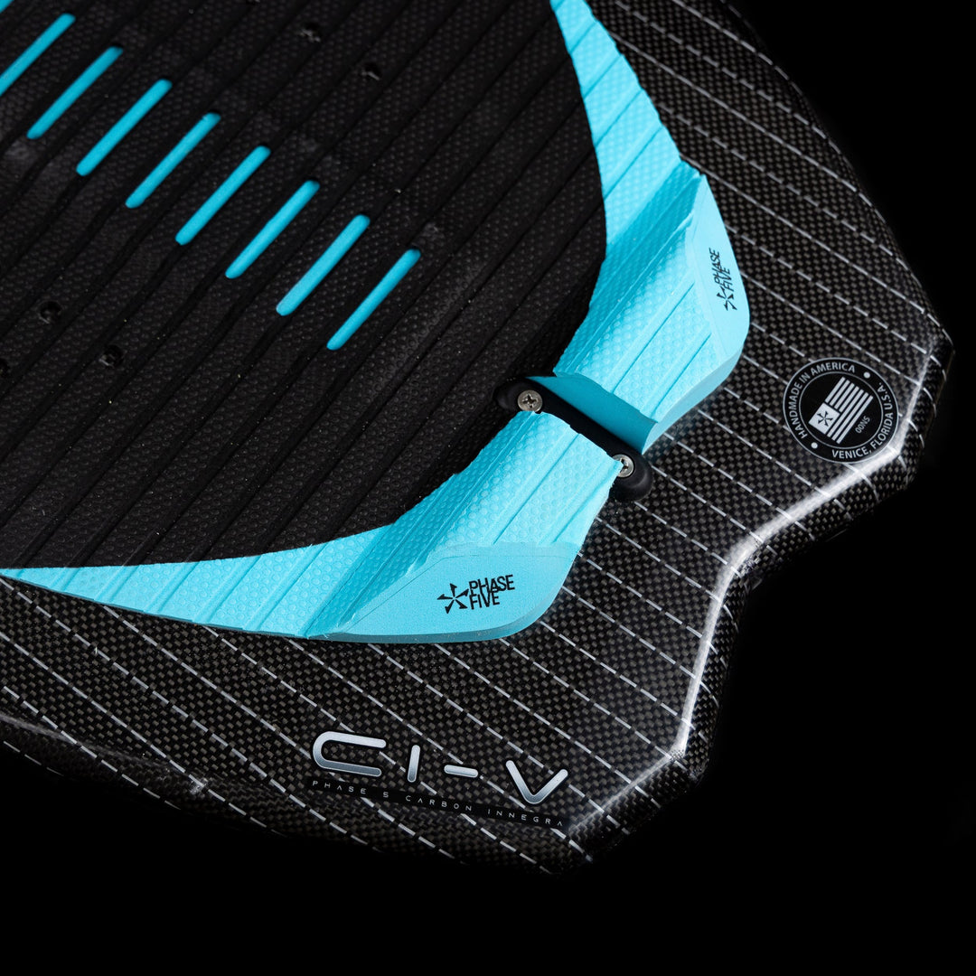 2026 Phase Five Hypsta V2 wake surfboard featuring a textured black surface with blue accents and adjustable fin system.