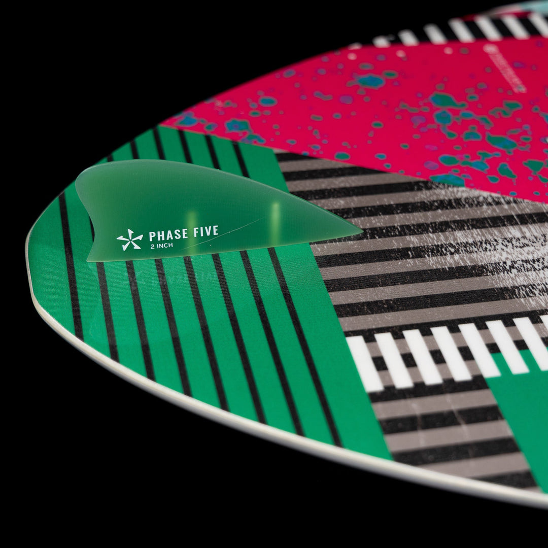 Close-up of the 2026 Phase Five Key CL surfboard showing vibrant graphics and a green fin attachment.