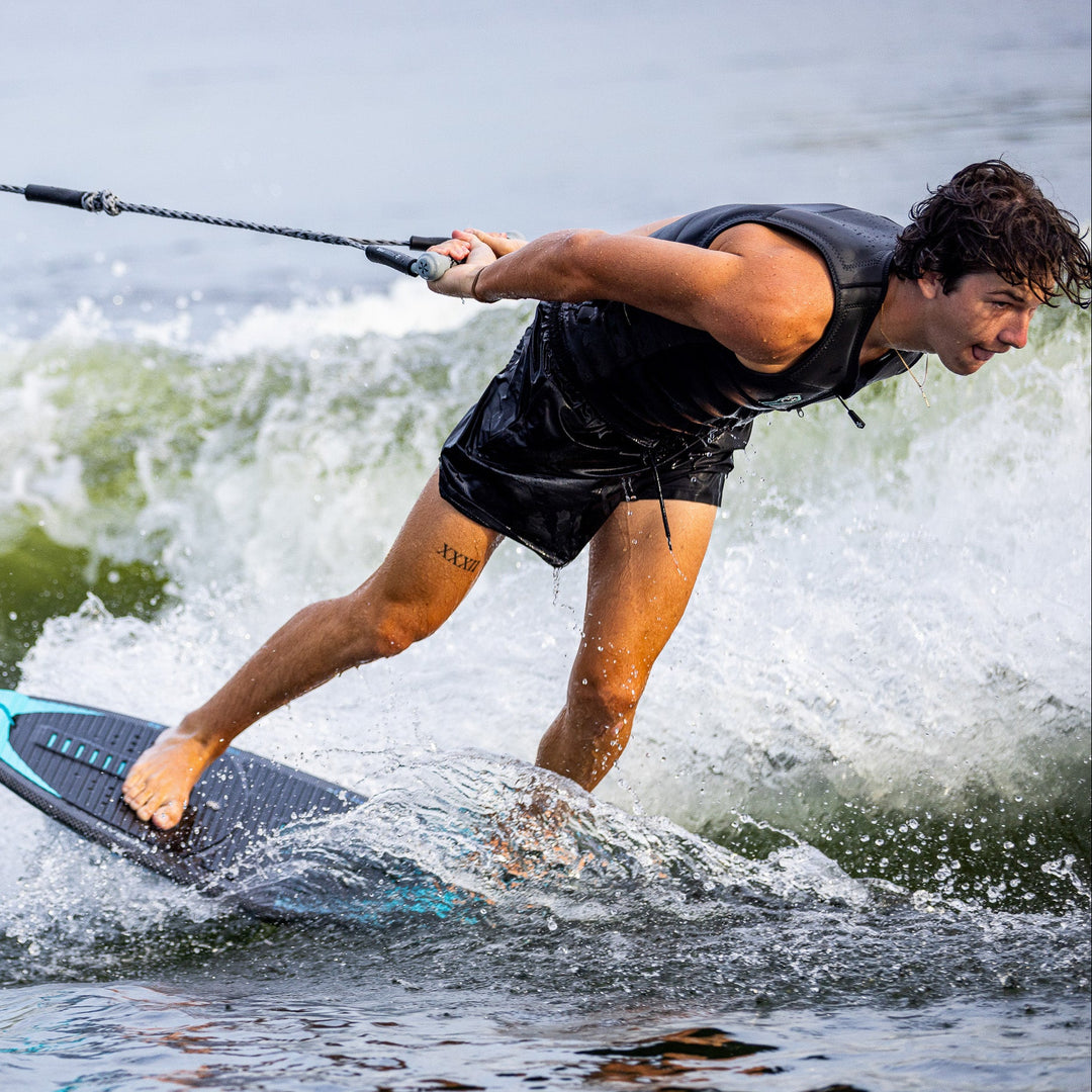 A rider performs a trick on the 2026 Phase Five Key Jett Shreds surfboard, showcasing agility and skill on the water.