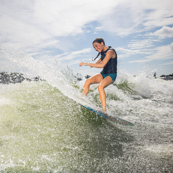 A person rides the 2026 Phase Five Key Stewart Pro surfboard on a wave, showcasing skill and excitement on the water.