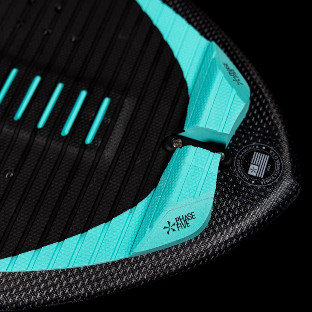 Close-up of the 2026 Phase Five Matrix Pro wake surfboard showing textured black surface and aqua accents for grip.