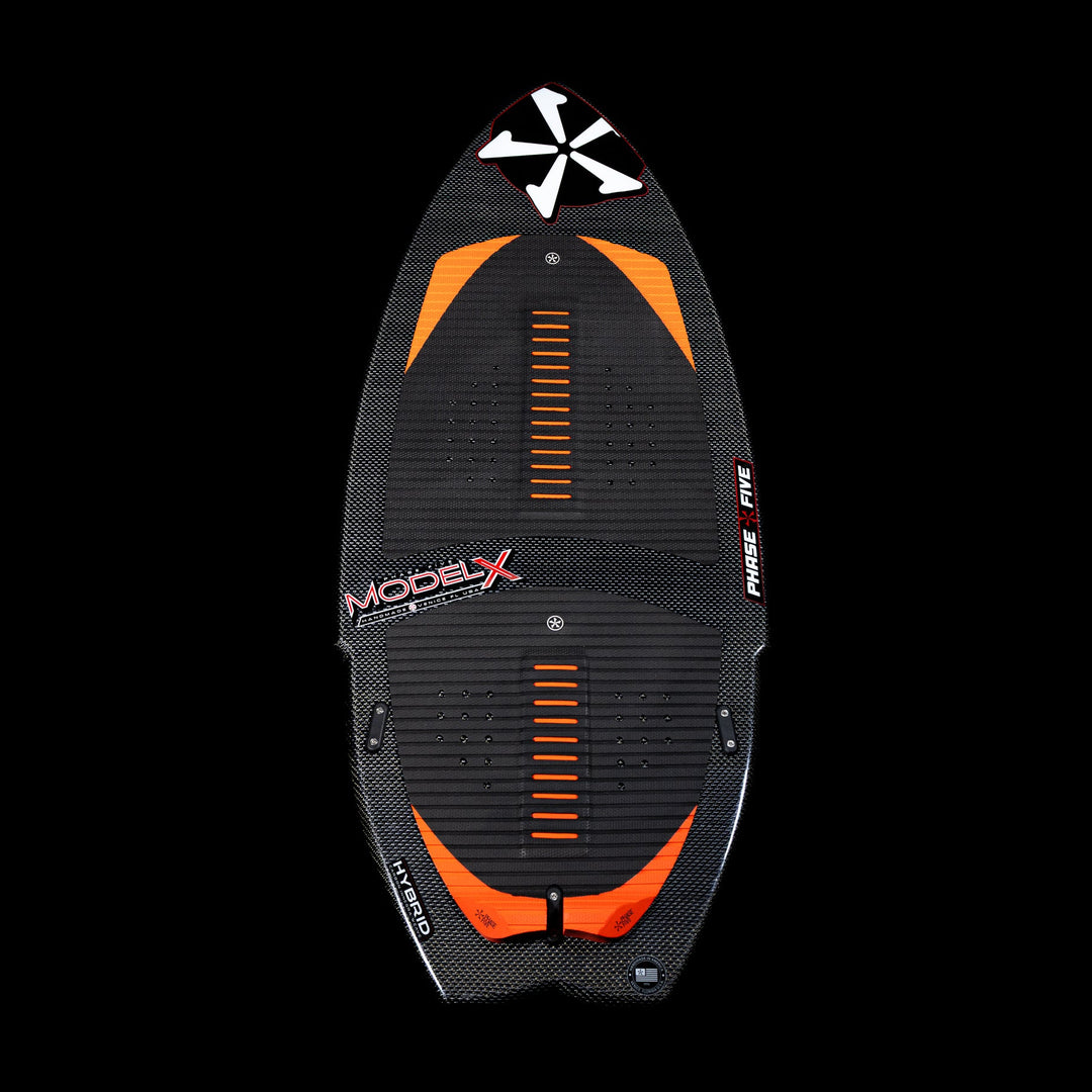 2026 Phase Five Model X wakesurf board featuring a sleek black design with orange accents and textured footpads.