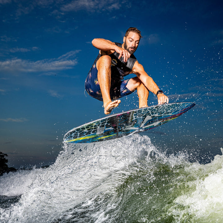 A rider performs a jump on the 2026 Phase Five MVP V4 surfboard, showcasing dynamic movement over a wave.