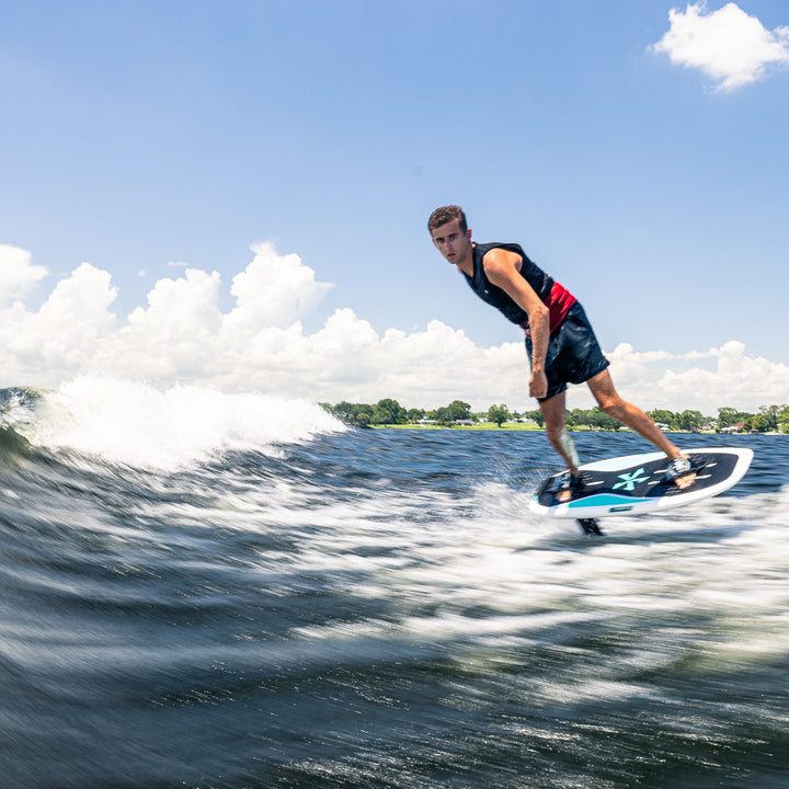 A rider skillfully maneuvers the 2026 Phase Five Phantom Foil on a wave, showcasing its performance and design.