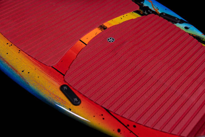 Close-up of the 2025 Phase 5 Scamp skim board featuring a vibrant design and textured grip pads for enhanced traction.