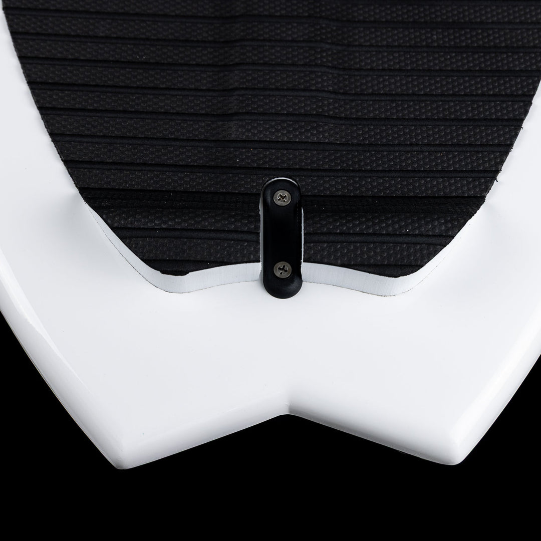 Close-up of the 2026 Phase Five Surfari surfboard showing the sleek white design and textured black traction pad.