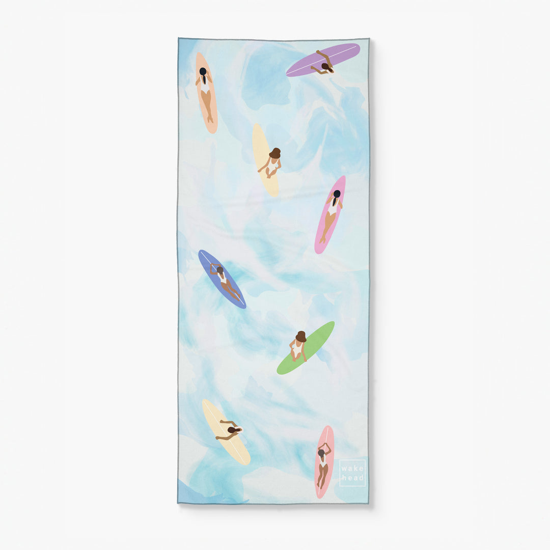 Wake Head Tide Chaser Lake Towel featuring colorful paddleboarders on a blue and white water-inspired background.
