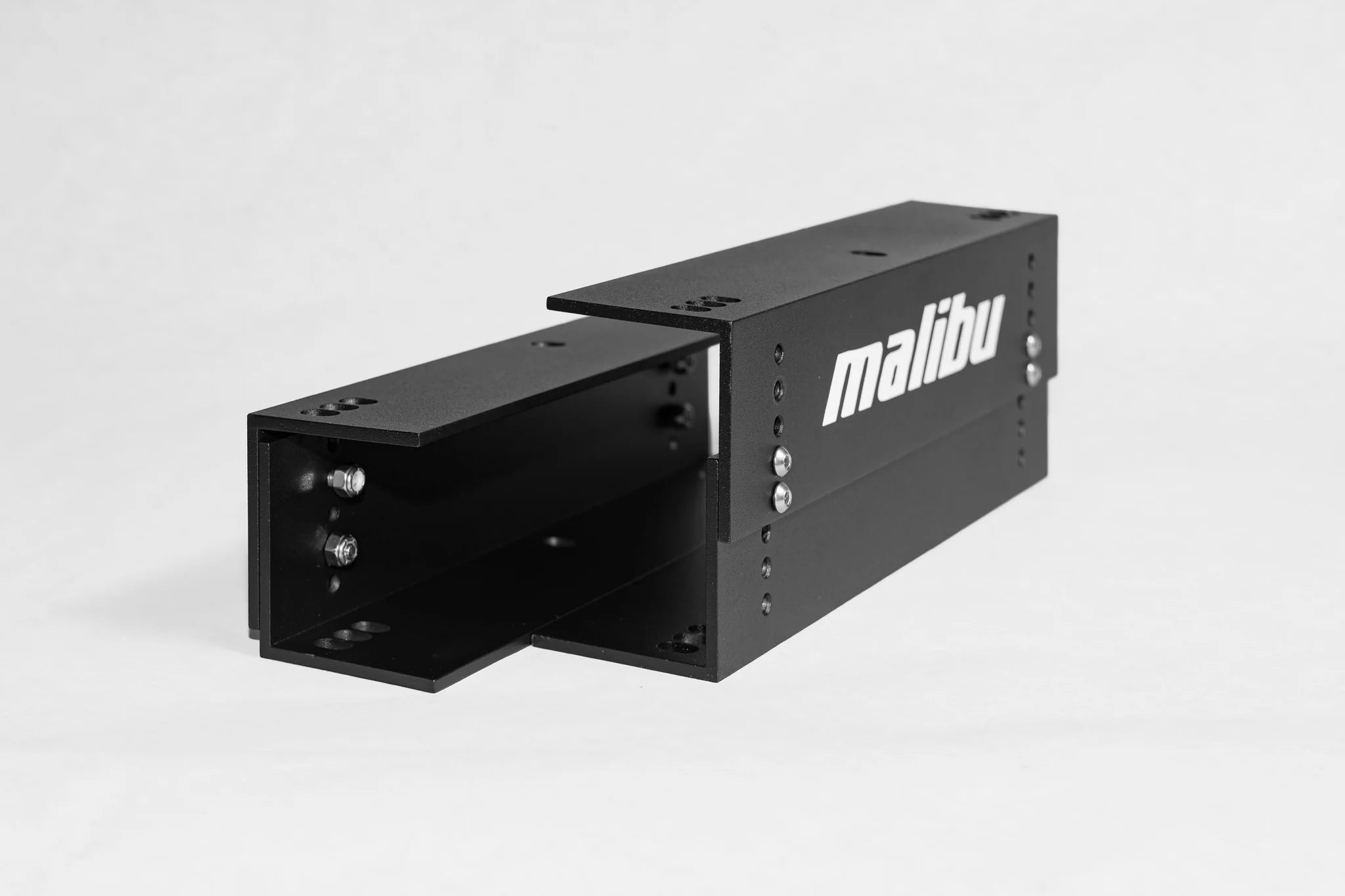 Black Malibu/Axis seat riser with metal bolts and "malibu" logo, designed to elevate vehicle seats for improved comfort.