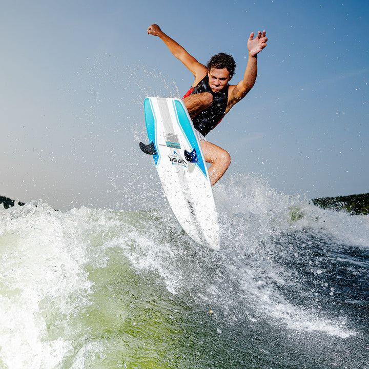 A rider performs an aerial maneuver on the 2026 Phase Five Viper surfboard, creating splashes on the water.