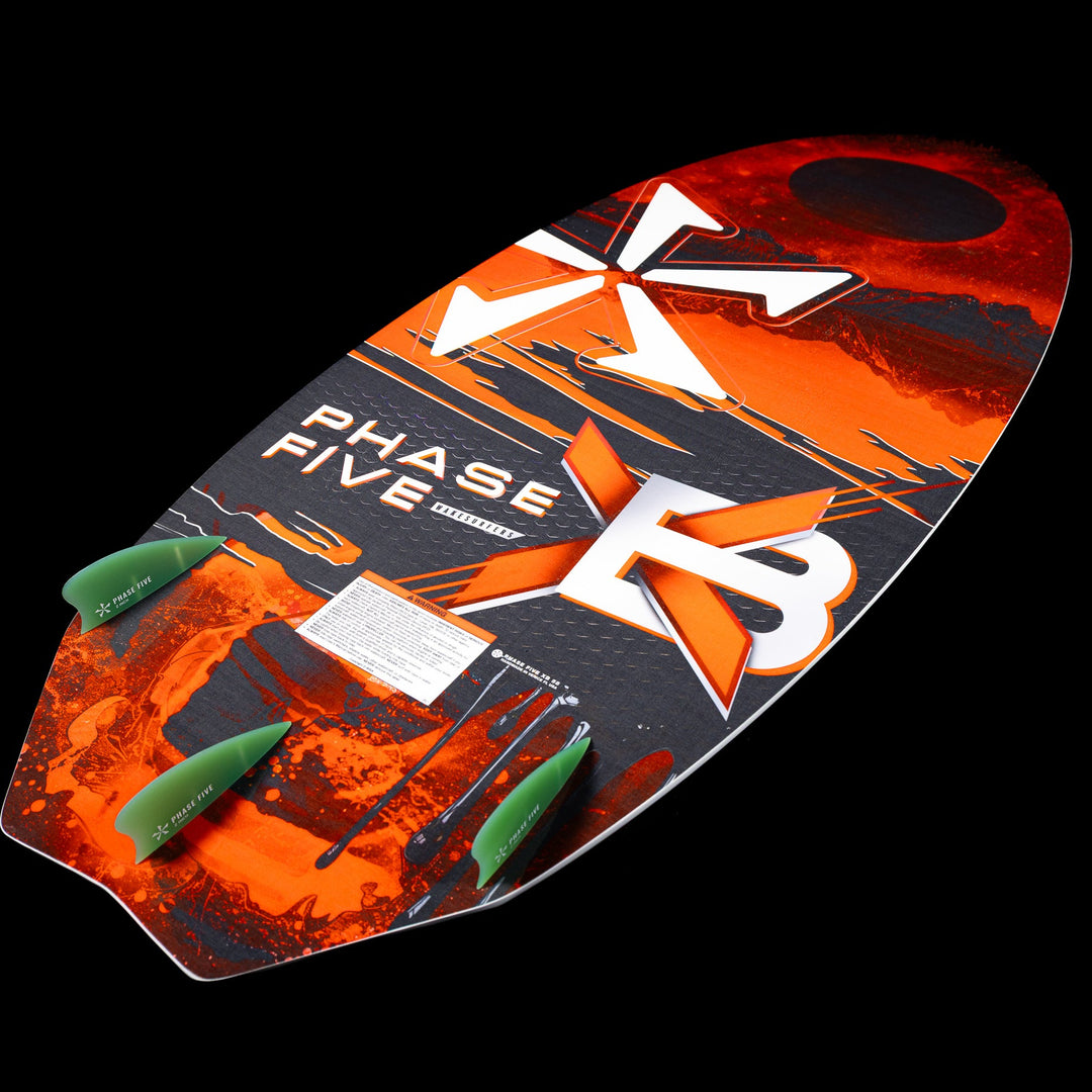 2026 Phase Five XB wake surfboard featuring a vibrant orange and black design with three green fins for enhanced performance.