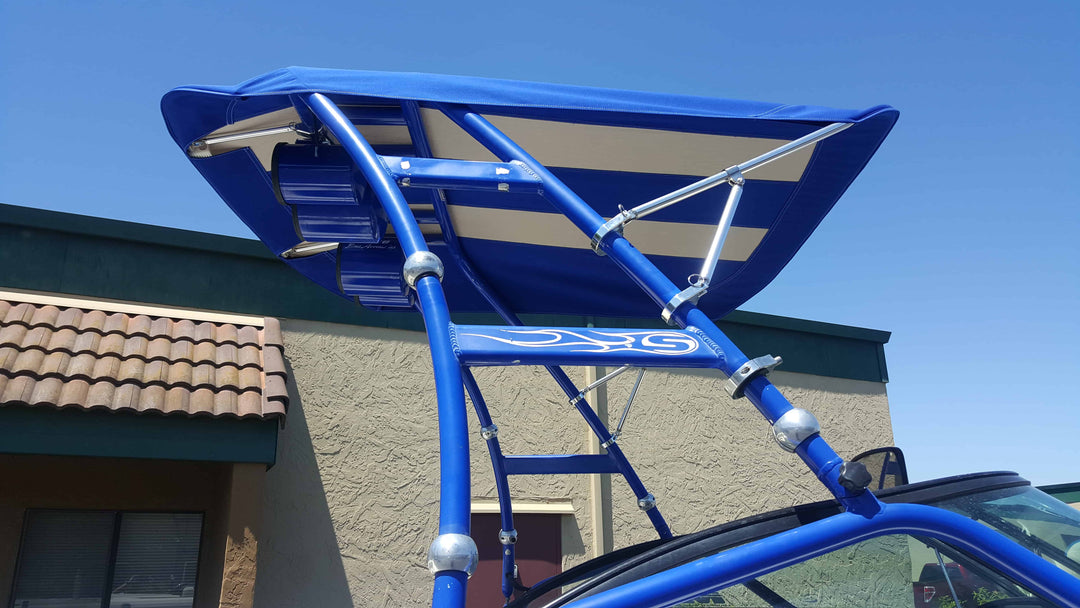 Over the Tower Bimini installed on a Skylon Swoop Tower, featuring a blue fabric cover and metal support bars against a clear sky.