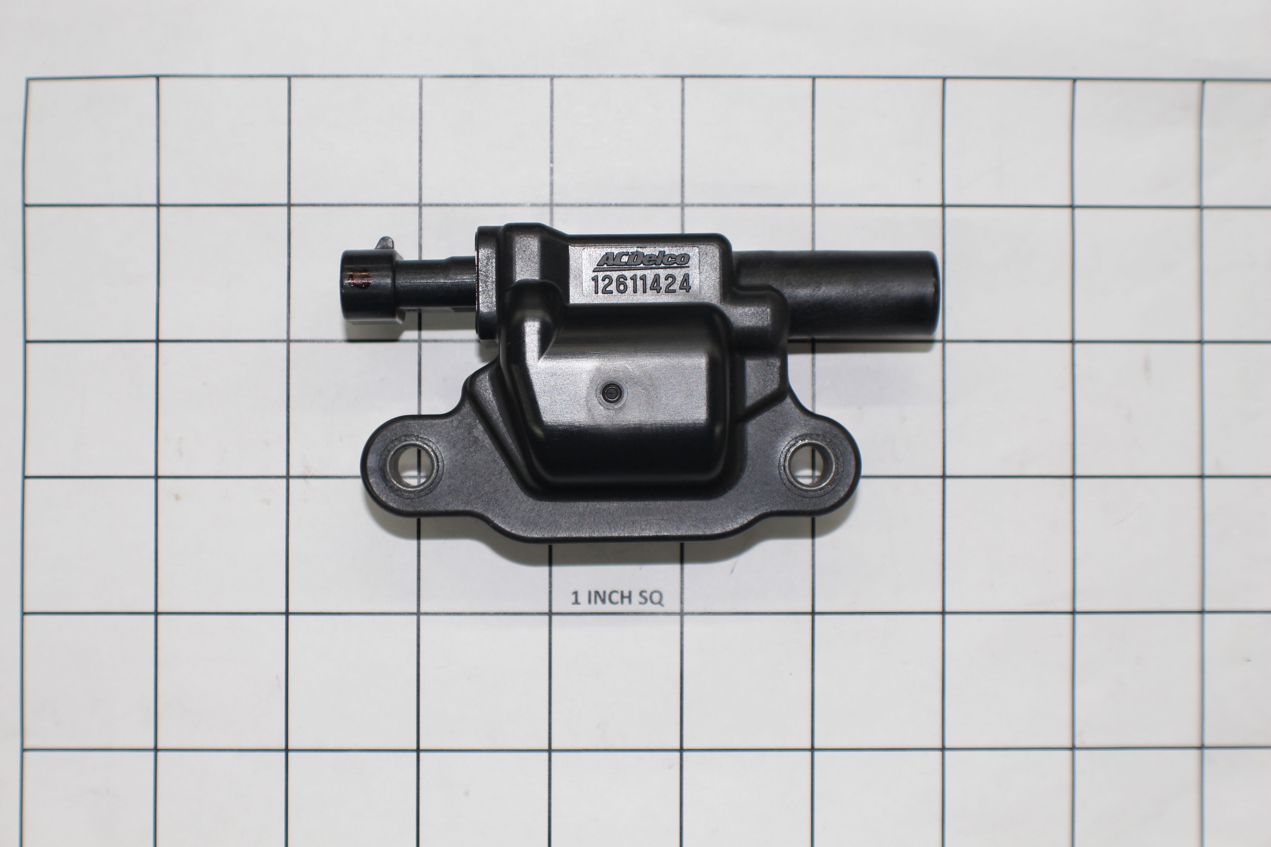 Coil ignition for L96, LS3, and LSA engines, black plastic and metal component with mounting holes and connector.