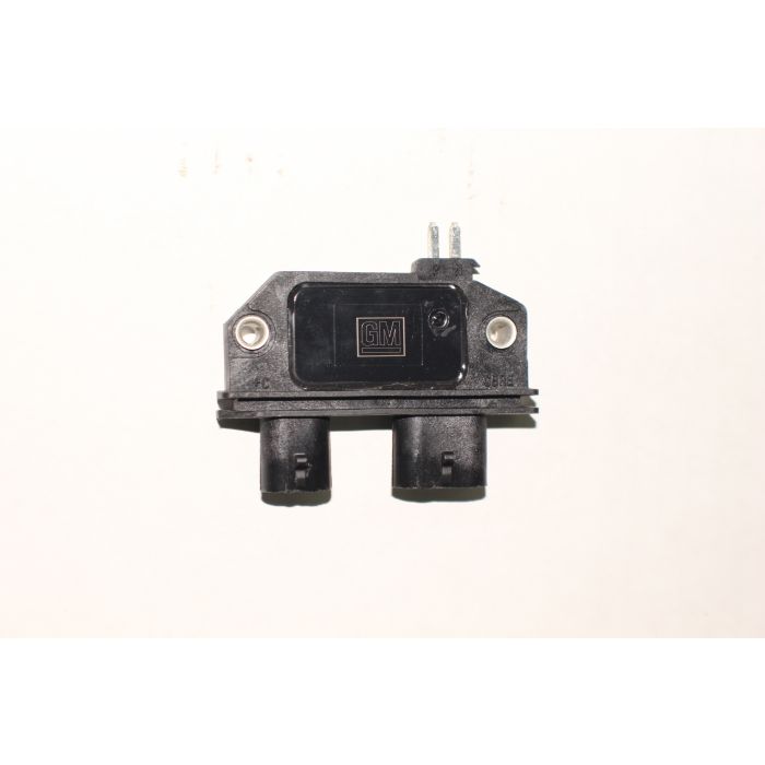 Module distributor ignition with GM branding, black plastic housing, and electrical connectors for vehicle ignition system.
