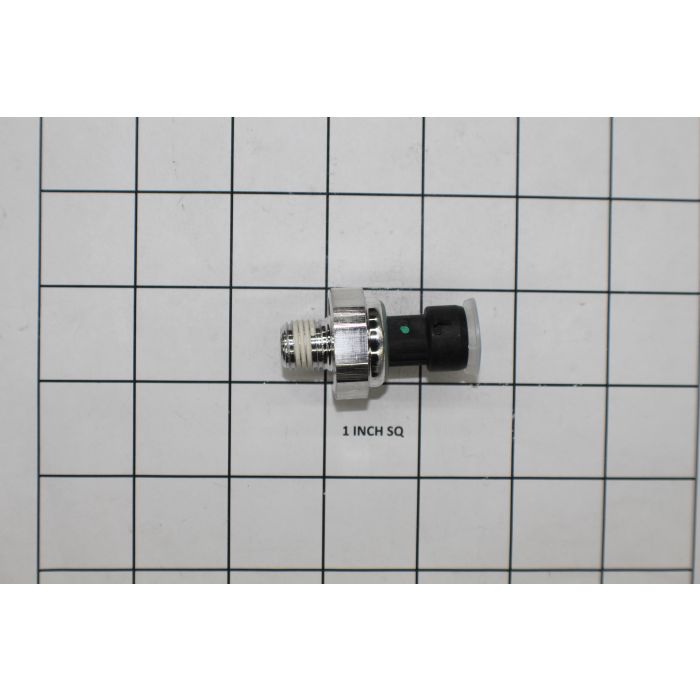 Sensor oil pressure 6.2 for Ford, small metallic and black component with threaded end, on a grid background for size reference.