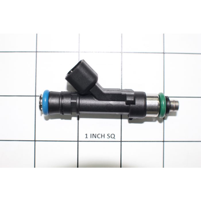 Close-up of a fuel injector with colored seals, placed on a grid background for size reference.