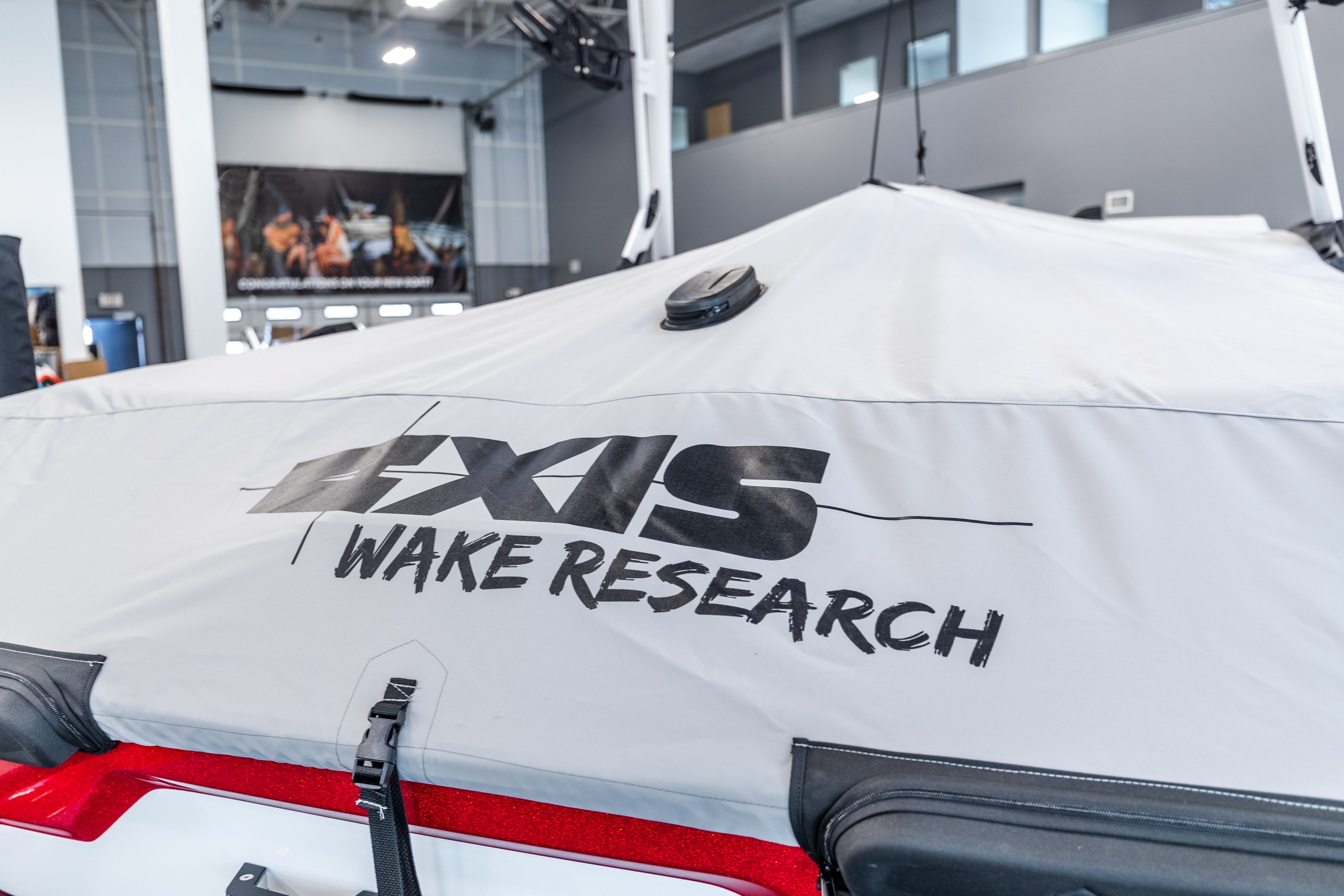 White cover with "GS Wake Research" logo, designed for a GS Tower with swim platform, inside a showroom.