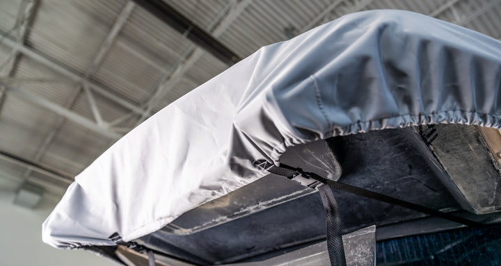 Swim platform cover for Axis boats (2013-2024), shown secured with straps over the boat&