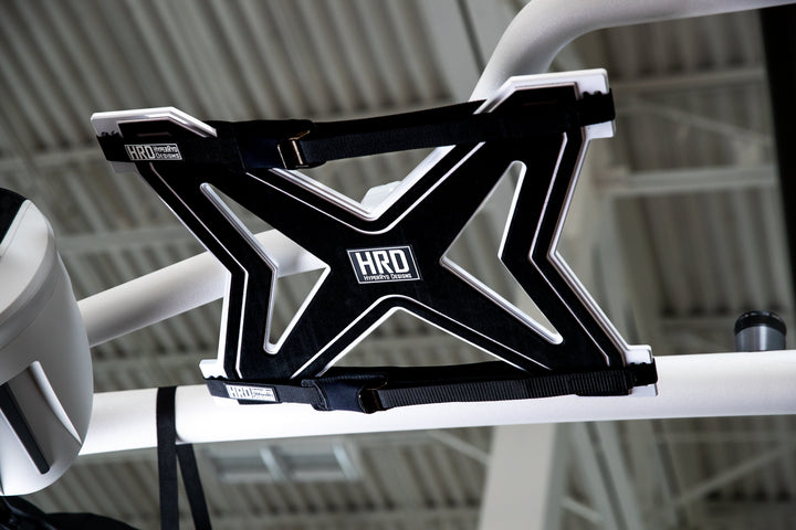 Black and white XR1 surf rack mounted on G3 and G5 towers, designed for carrying surfboards on a vehicle roof.
